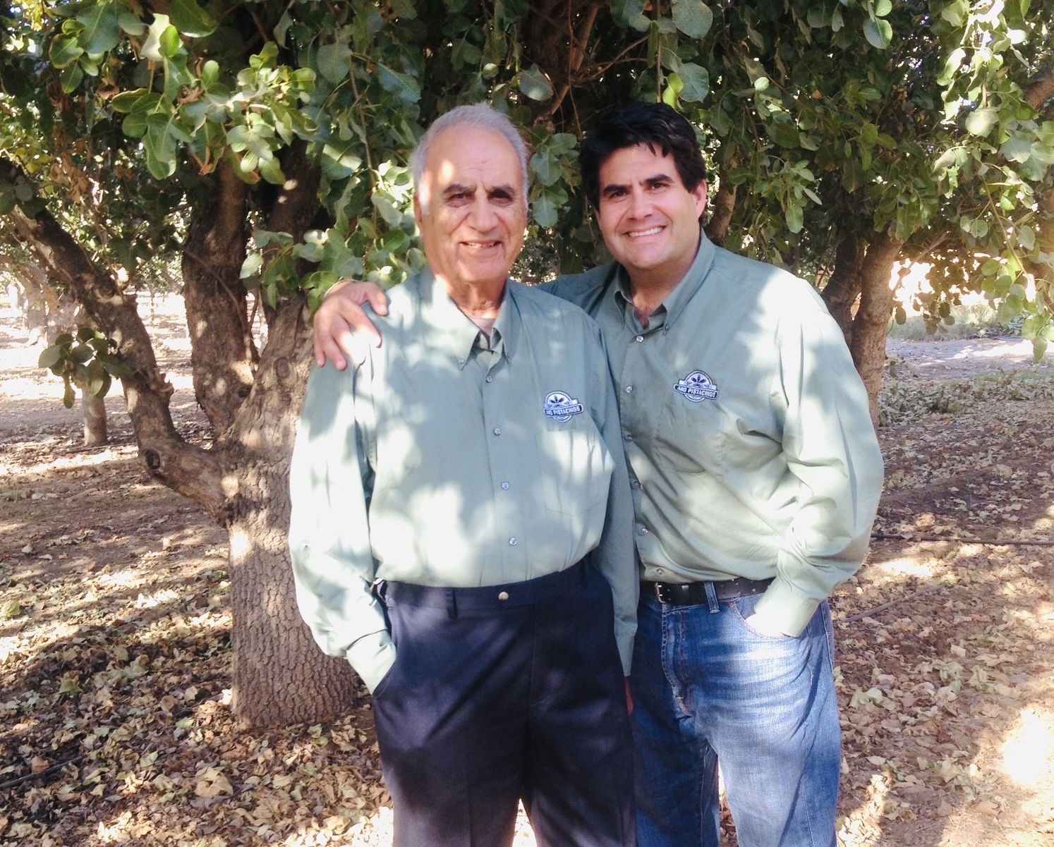 Adam Orandi with his father, Dr. Mehdi Orandi, in the Orandi Ranch orchards
